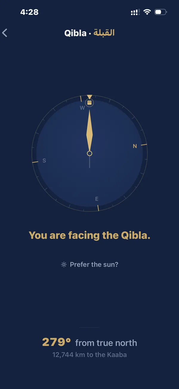 The qibla finder pointing toward the Kaaba, with a note about compass reliability.